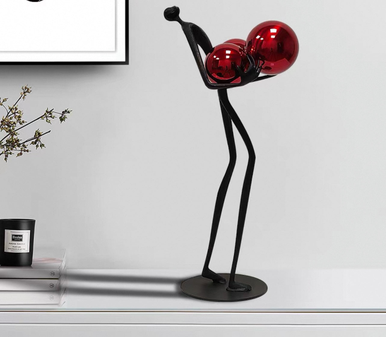 Sculpture man carry balls